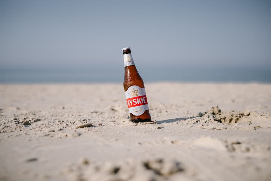 A polish beer on a sand