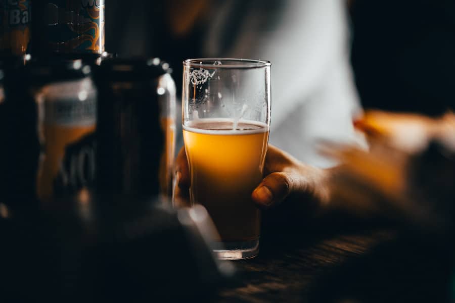 A person holding a glass of beer