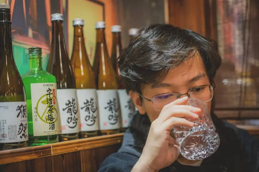 A person drinking sake