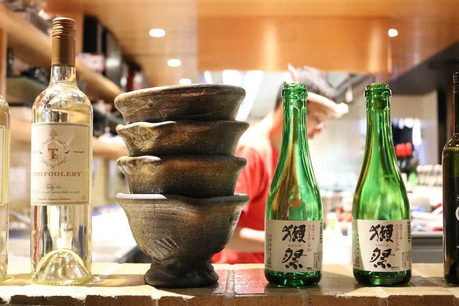 A bottle of sake with bowl