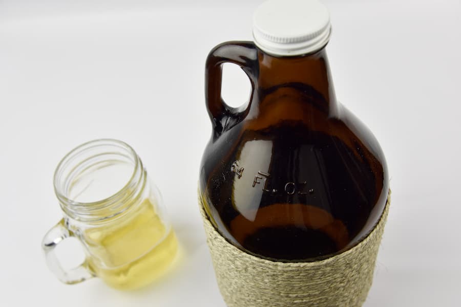 An image of a growler bottle and a mug