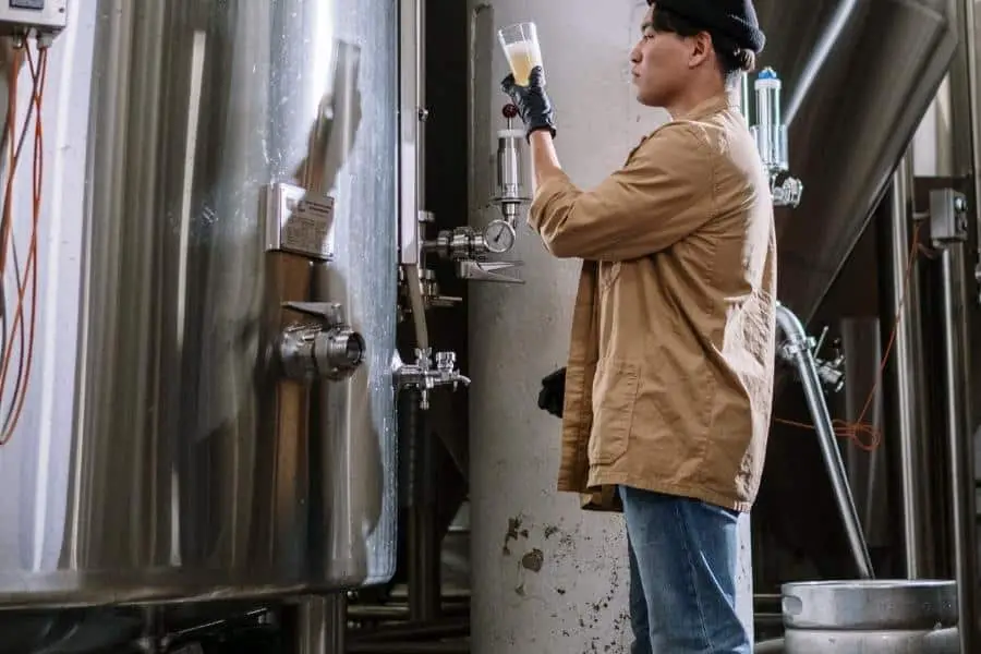 An image of a man checking the beer