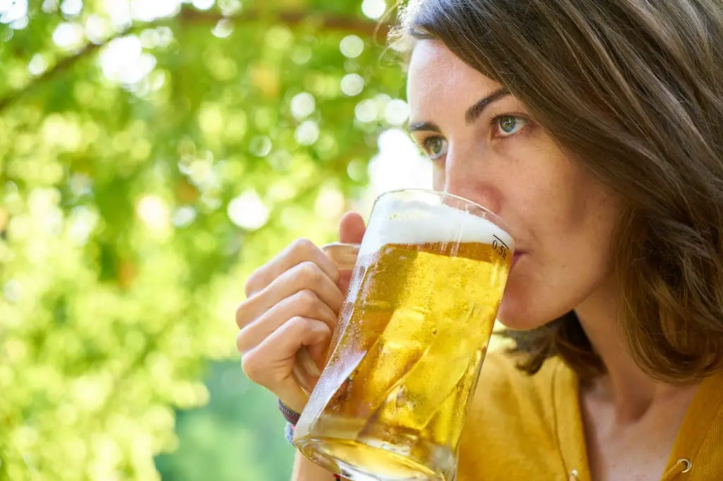 An image of a woman drinking beer