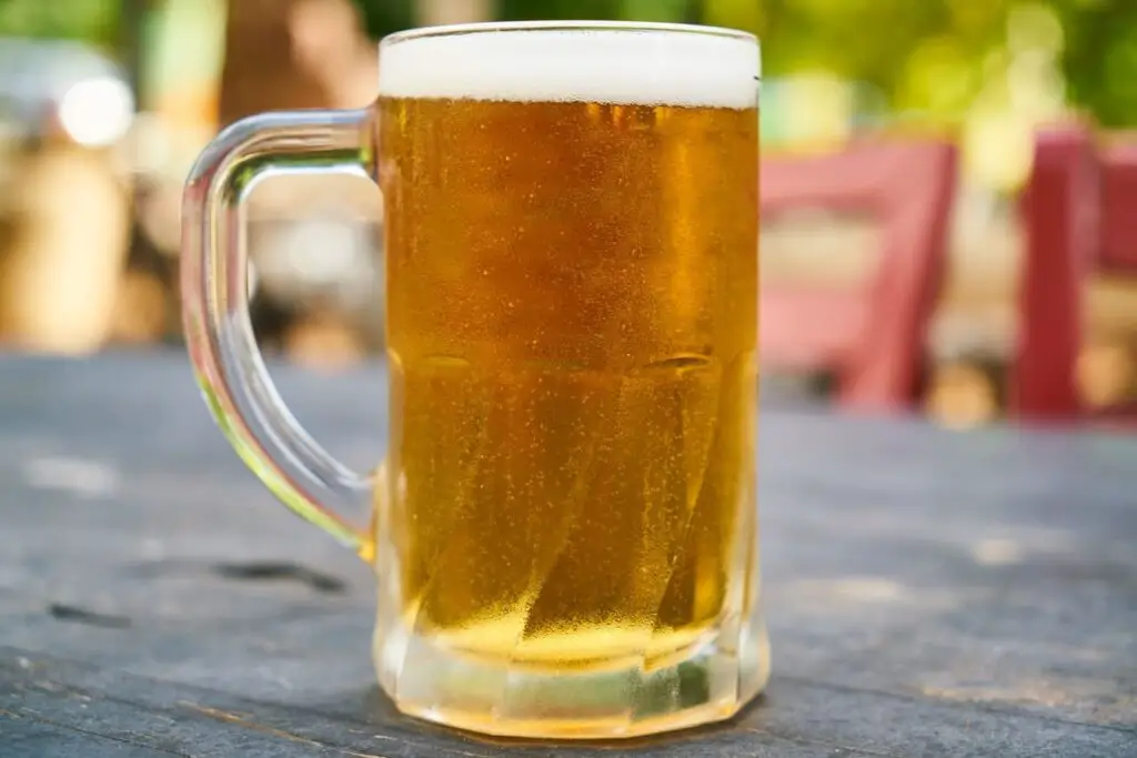 An image of mug filled with beer on the table