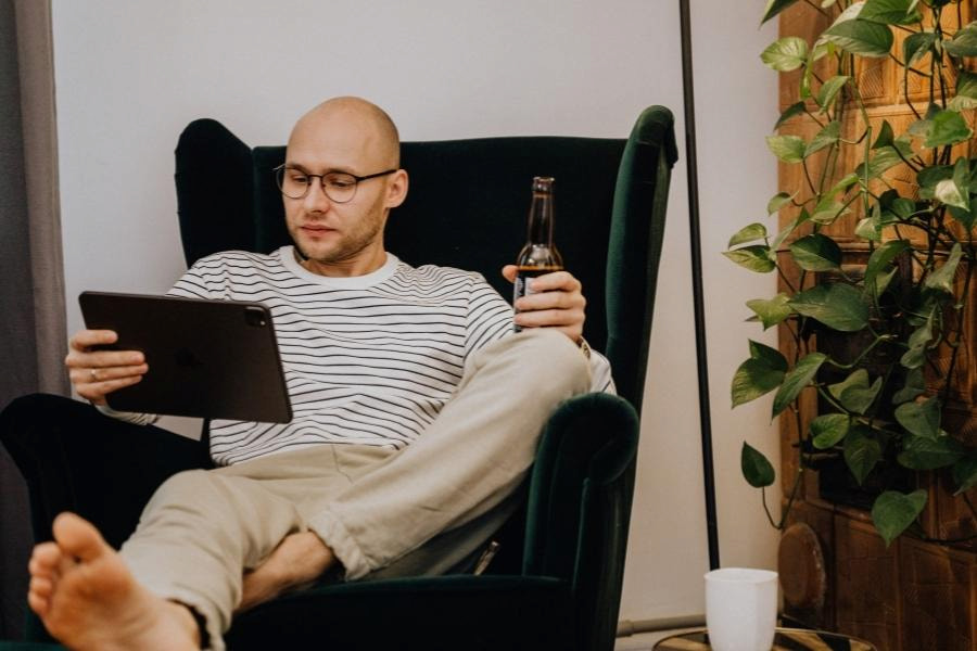 An image of man holding a bottle of beer