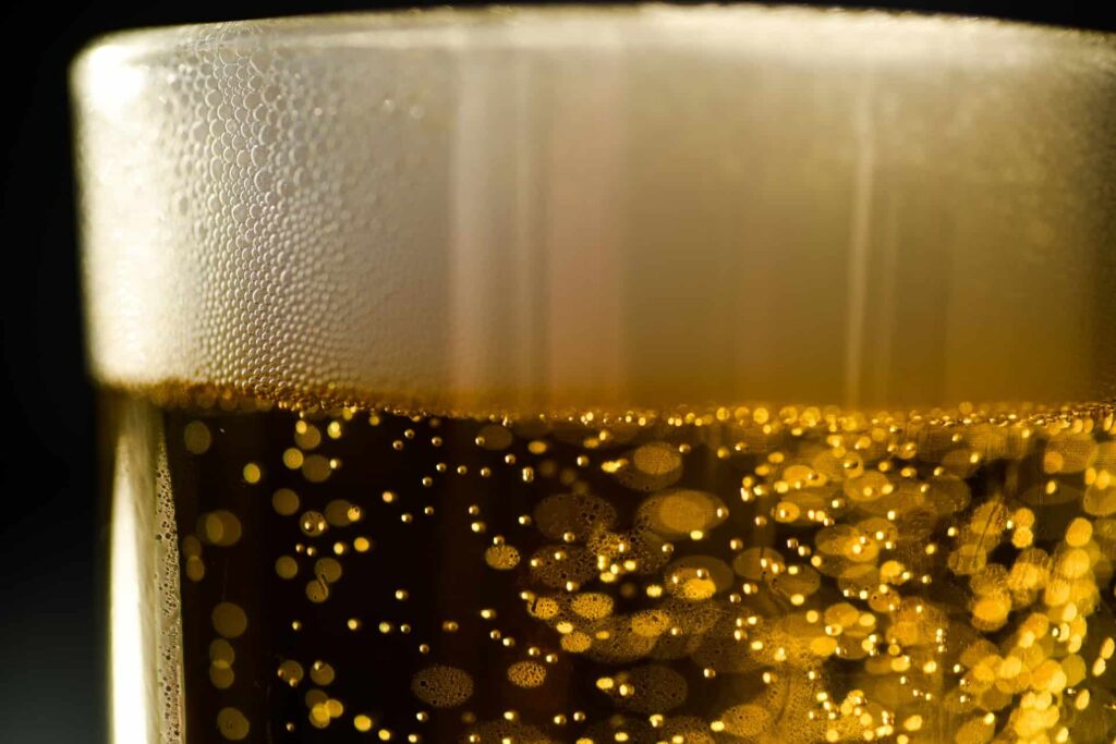 A close-up image of a glass of beer