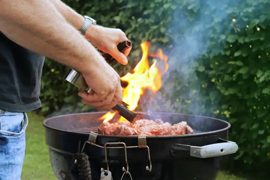An image of a man grilling meat