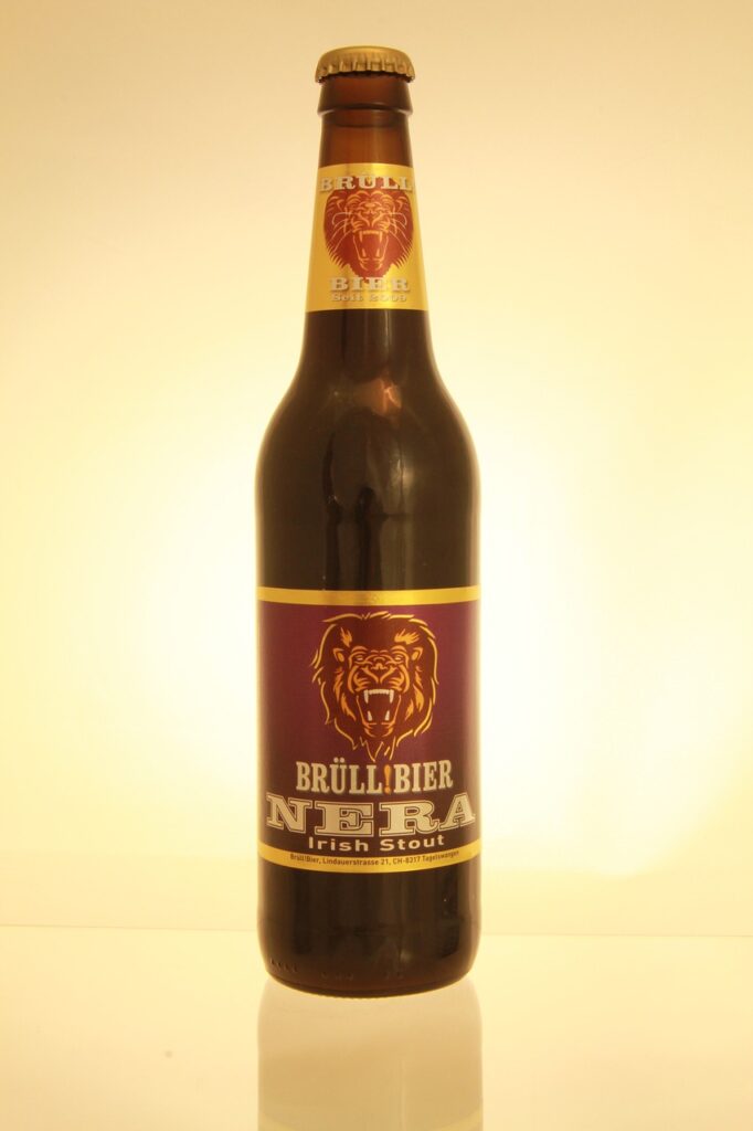 A brown bottle of Nera Irish stout with a brown cap was placed on a white surface